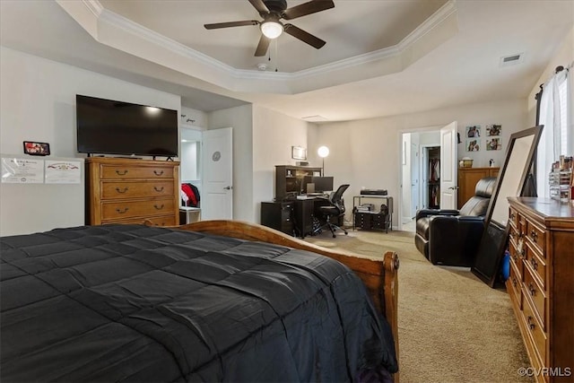 bedroom with ceiling fan, ornamental molding, a raised ceiling, and light carpet