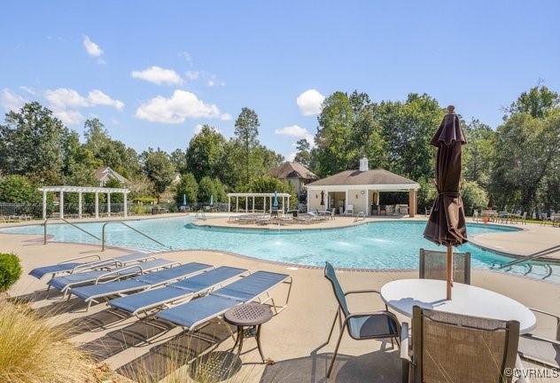 view of swimming pool featuring pool water feature, a gazebo, a pergola, and a patio