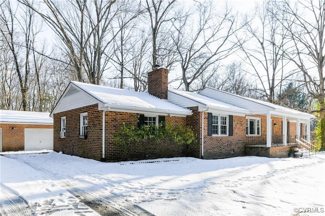 view of snowy exterior featuring a garage