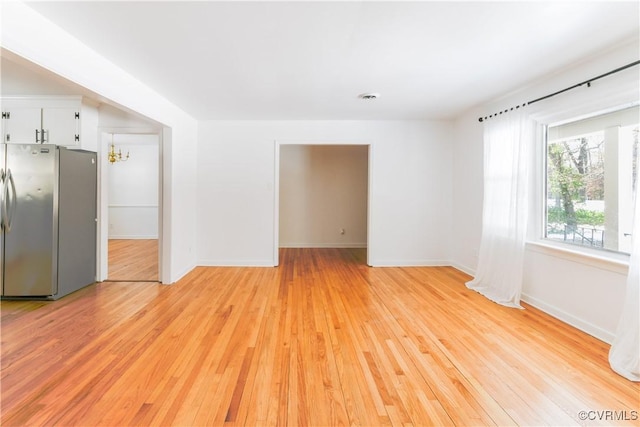 unfurnished room with light hardwood / wood-style floors