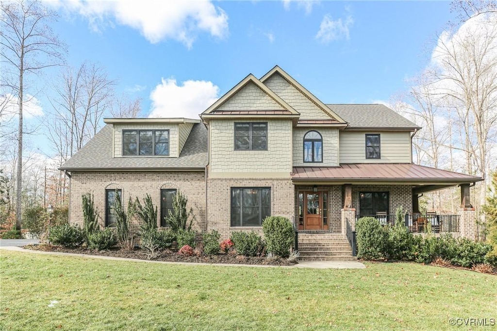 view of front of home featuring a front lawn and a porch