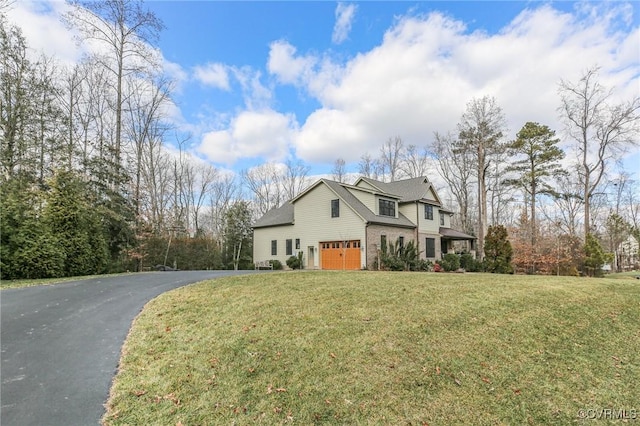 view of front of home featuring a garage and a front lawn