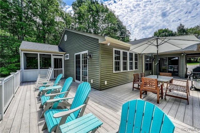 wooden terrace featuring area for grilling and a sunroom