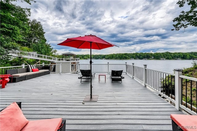 view of dock featuring a gazebo and a deck with water view