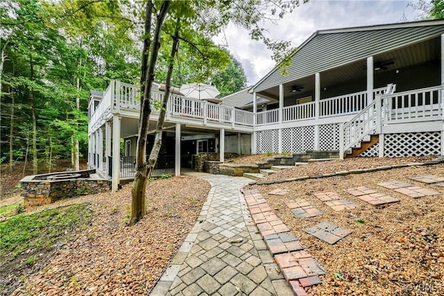 exterior space featuring ceiling fan and a deck