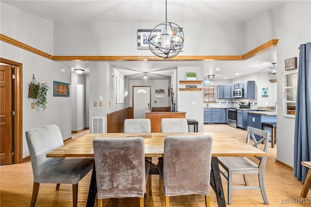 dining room with light hardwood / wood-style flooring and a chandelier