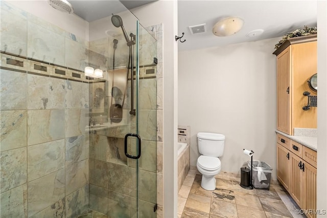 full bathroom featuring shower with separate bathtub, vanity, and toilet