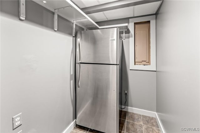 bathroom featuring electric panel and tile patterned flooring