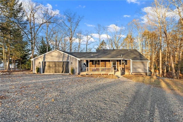 ranch-style house with a porch and a garage