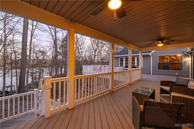 wooden deck featuring ceiling fan