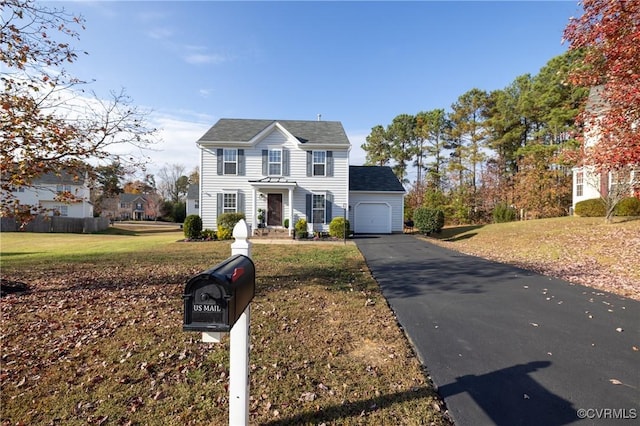 view of front facade featuring a front yard and a garage