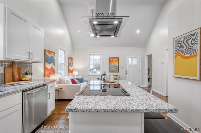 kitchen with high vaulted ceiling, white cabinets, dishwasher, and a kitchen island