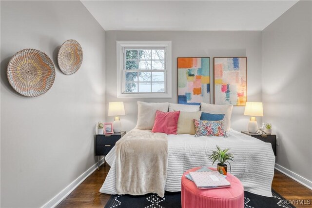 bedroom with dark wood-type flooring