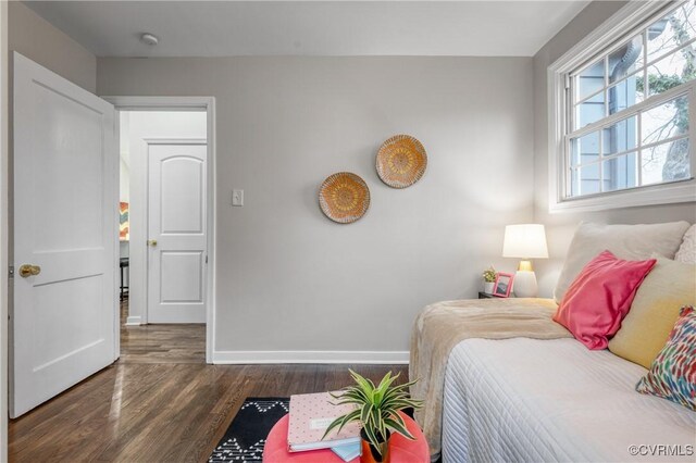 bedroom with dark wood-type flooring