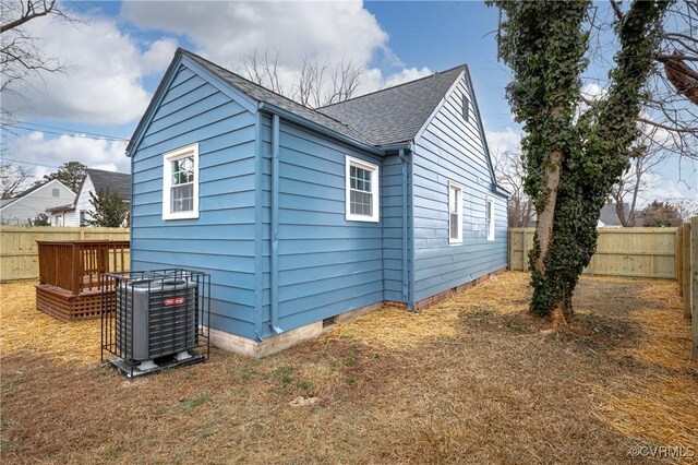 view of side of home with a deck and central air condition unit