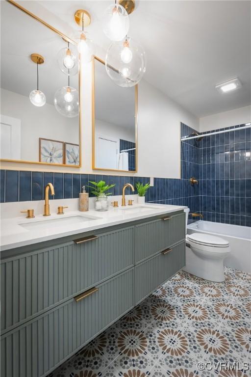 full bathroom with toilet, tiled shower / bath combo, decorative backsplash, tile patterned flooring, and tile walls