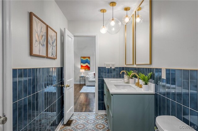 bathroom featuring tile walls, tile patterned floors, vanity, and toilet