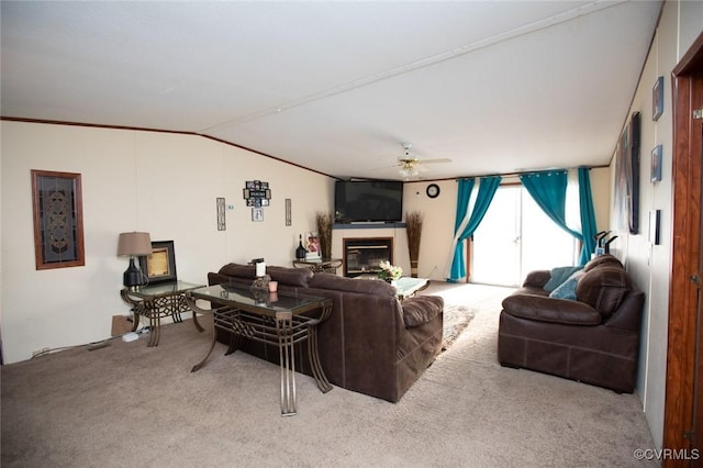 living room featuring ceiling fan, lofted ceiling, and light colored carpet