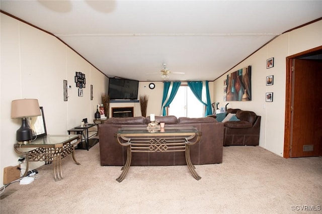 living room featuring lofted ceiling, ceiling fan, and carpet flooring