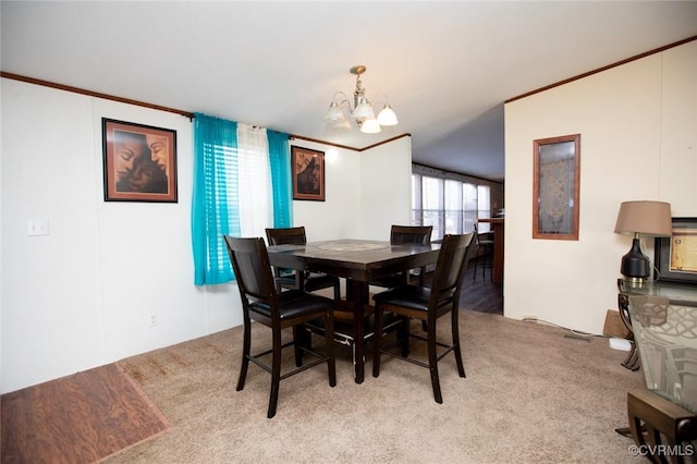 dining space featuring light carpet, an inviting chandelier, and ornamental molding