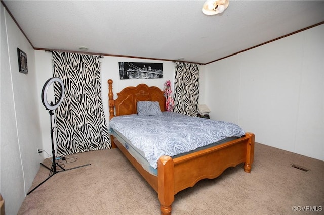 bedroom featuring crown molding and light carpet