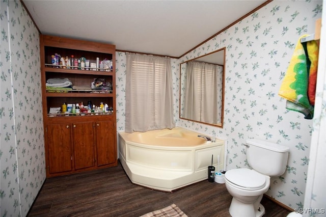 bathroom featuring toilet, a bathing tub, crown molding, and wood-type flooring