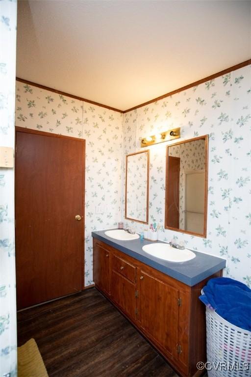 bathroom featuring hardwood / wood-style flooring, vanity, and crown molding