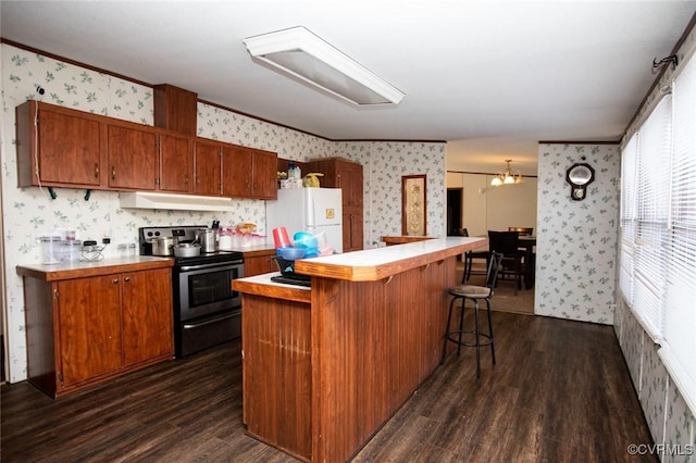 kitchen featuring white fridge, ornamental molding, dark hardwood / wood-style floors, and stainless steel electric range