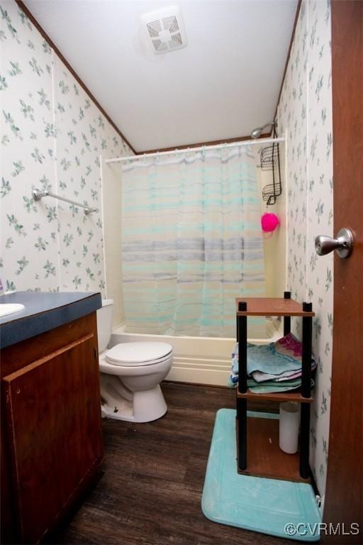 full bathroom featuring toilet, hardwood / wood-style flooring, shower / tub combo, crown molding, and vanity