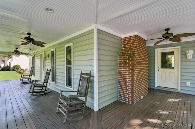 wooden terrace featuring covered porch and ceiling fan