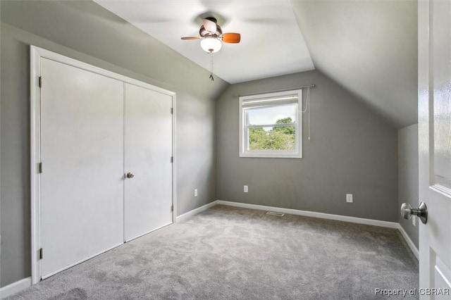 additional living space with ceiling fan, lofted ceiling, and light colored carpet