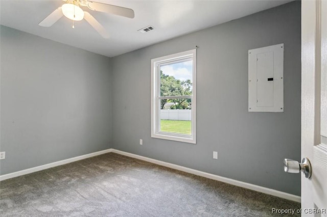 carpeted empty room with ceiling fan and electric panel