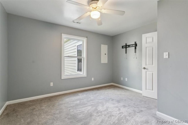 unfurnished room featuring ceiling fan, light colored carpet, and electric panel