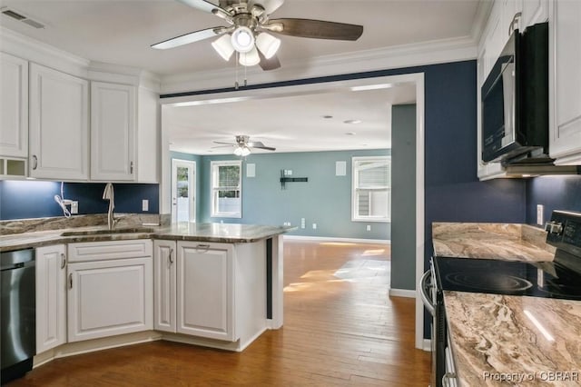 kitchen with dark hardwood / wood-style floors, sink, white cabinets, and black appliances