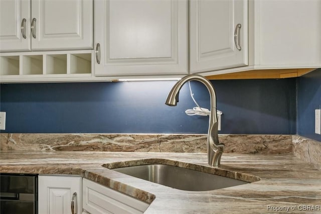 kitchen featuring white cabinets and sink