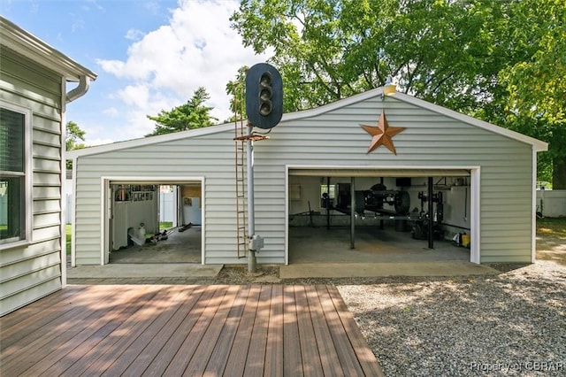 wooden terrace with a garage and an outbuilding