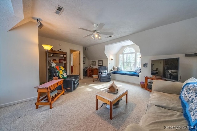 carpeted living room with ceiling fan, lofted ceiling, and a textured ceiling