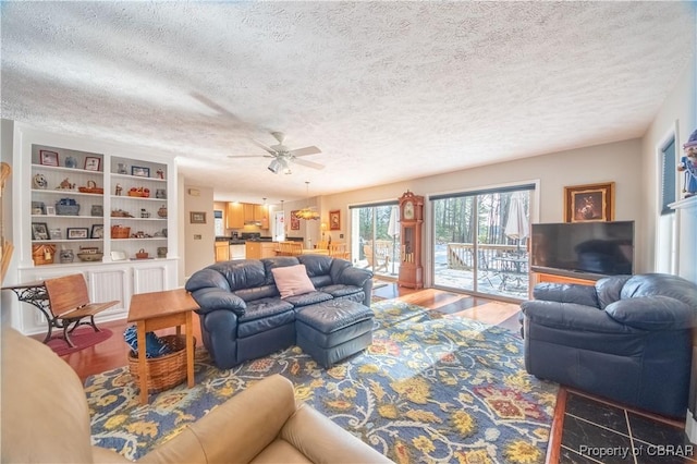 living room with wood-type flooring and a textured ceiling