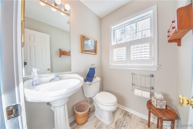 bathroom featuring sink, toilet, and hardwood / wood-style floors