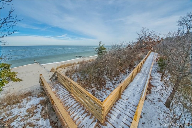 surrounding community featuring a beach view and a water view