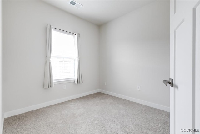 empty room featuring plenty of natural light and light colored carpet