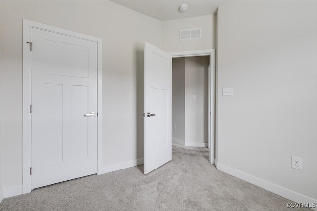 unfurnished bedroom featuring light carpet