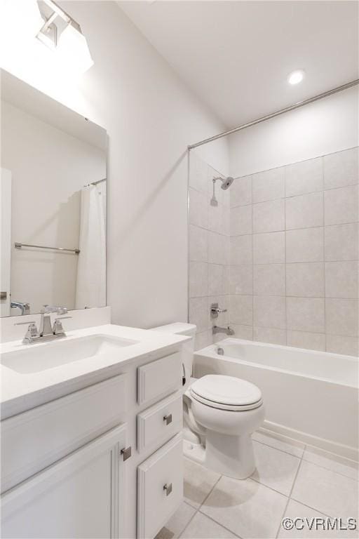 full bathroom featuring shower / bath combo with shower curtain, tile patterned floors, vanity, and toilet