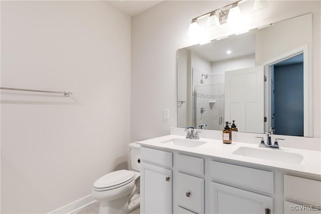 bathroom featuring tile patterned flooring, toilet, a shower with door, and vanity