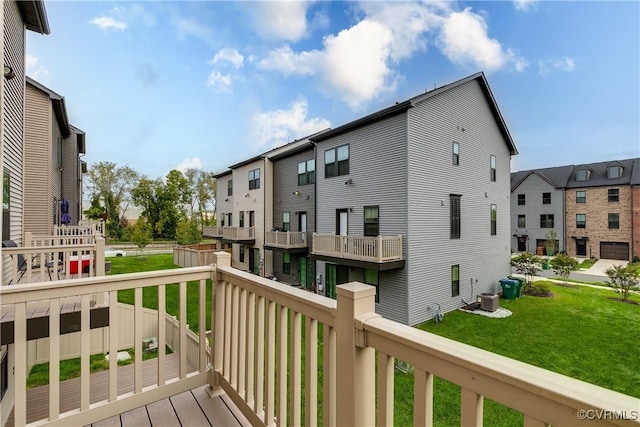 wooden terrace featuring central AC and a yard