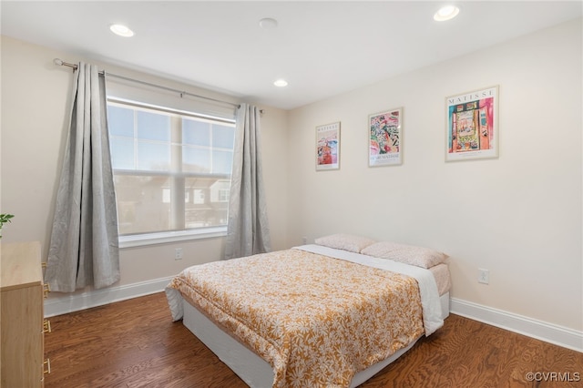 bedroom with dark wood-type flooring