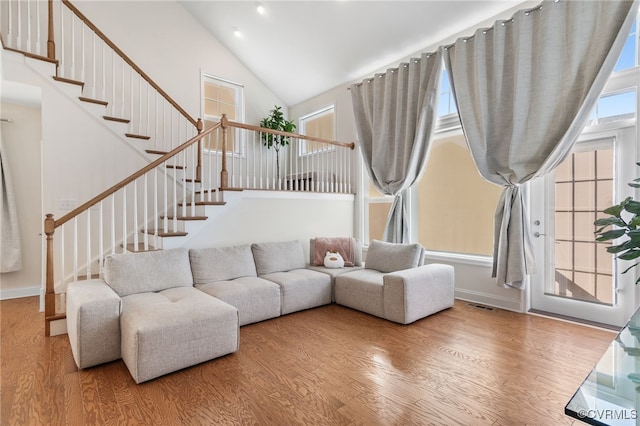 living room featuring hardwood / wood-style floors and vaulted ceiling