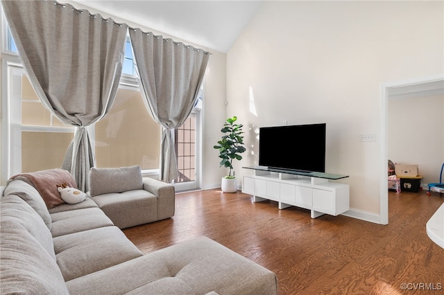 living room featuring hardwood / wood-style floors and vaulted ceiling