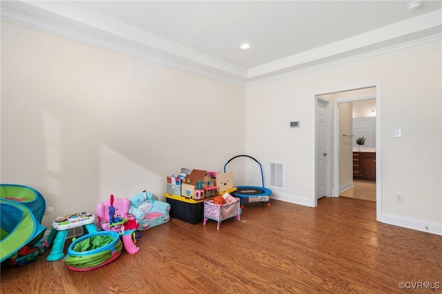 game room featuring hardwood / wood-style floors and crown molding