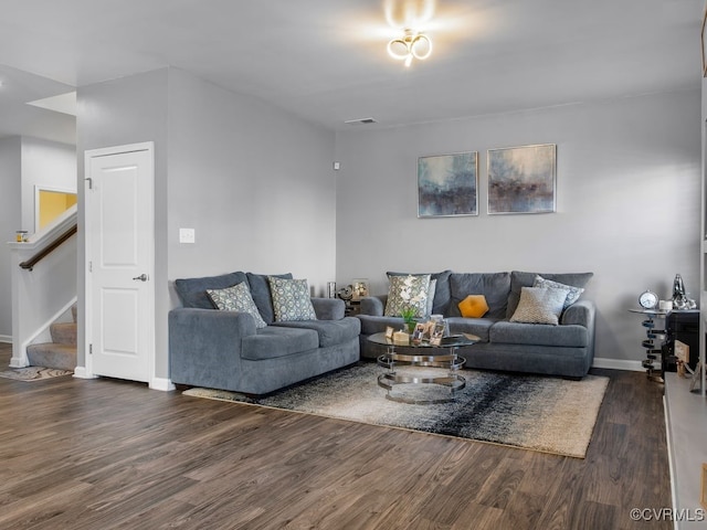 living room with dark hardwood / wood-style flooring